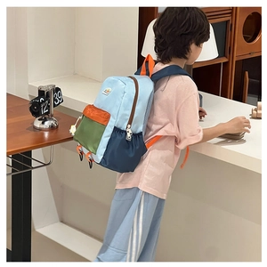 Detail shot of a color-block waterproof nylon backpack for kids with adjustable straps