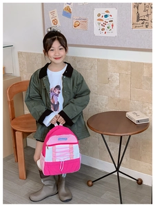 Pink and white colorblock kids backpack with criss-cross drawstring and blue logo patch