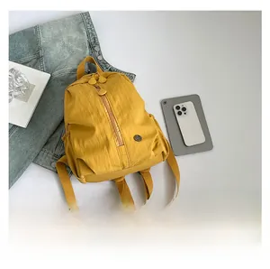 Detailed top view of a yellow waterproof nylon backpack with a multi-pocket structure
