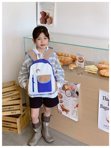 Detail of kids lightweight rainbow backpack with blue-white contrast and patch embroidery