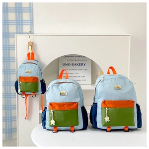 Detailed set of three color-block nylon backpacks with contrast straps and pockets
