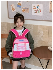 Close-up of pink and white kids' backpack with elastic drawstring and brand logo