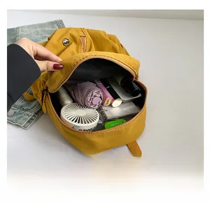 Interior view of yellow kids backpack showing large capacity with daily essentials