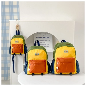 Detailed size comparison of three colorful patchwork school backpacks in yellow and blue
