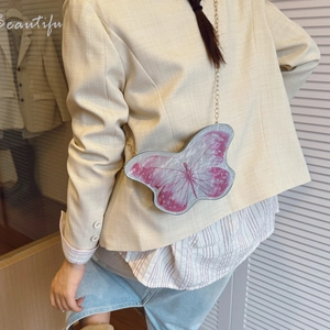 Cute butterfly-shaped crossbody bag with pink wings and elegant gold chain strap