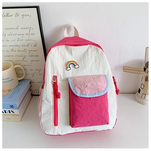 Detail of colorful kids' backpack with rainbow patch and multi-compartment design
