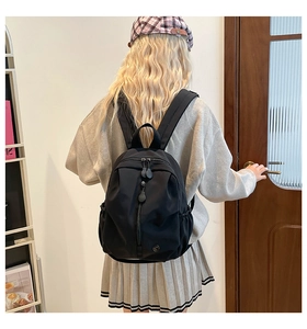 Detail of waterproof black backpack showing large capacity and multi-pocket design