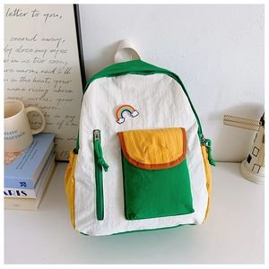 Detail of color-block kids backpack with rainbow embroidery and side storage pocket