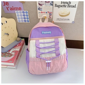 Close-up of pink and purple drawstring backpack with Fasbag embroidery and side pockets