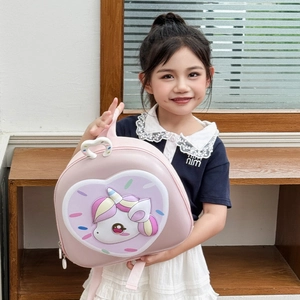 3D unicorn shell backpack for toddlers with rainbow donut patterns in a cozy room setting