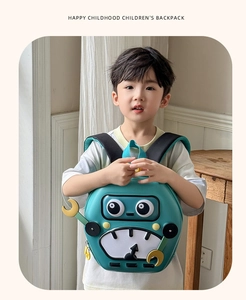 Detail of green robot hard shell backpack for kids featuring cute 3D design and handles