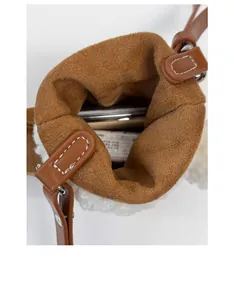 Interior view showing capacity of brown suede crossbody bag with fleece trim and phone space