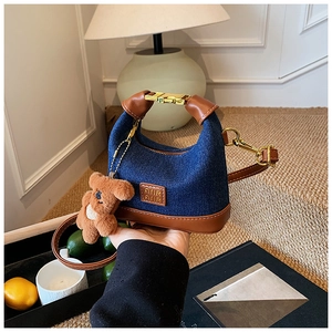 Mini denim handbag for girls with brown leather trim and a cute plush bear charm