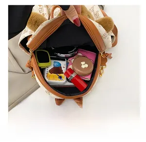 Top view of beige printed bear backpack interior showing large capacity for essentials