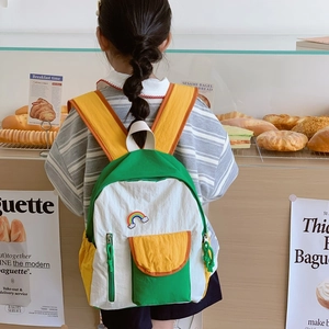 Lightweight rainbow schoolbag with green, white, and yellow stitching for children