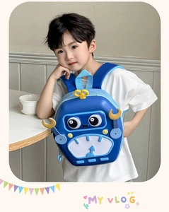 Blue robot hardshell backpack for kids with gears and glowing eyes worn by child