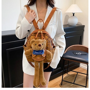 Brown monogram backpack featuring a 3D plush teddy bear with blue scarf detail