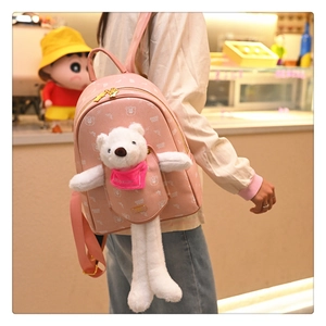 Close-up of pink girls' backpack with plush bear pendant and Lotso bear pattern print
