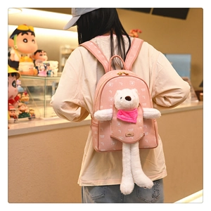 Detailed view of pink cartoon bear backpack showing plush doll and printed patterns