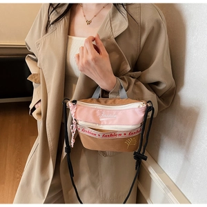 Detail of trendy canvas crossbody bag featuring fashion lettering and leaf embroidery