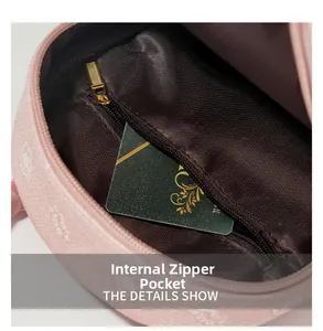 Detailed macro view of the interior zip pocket and brown lining in pink bear backpack