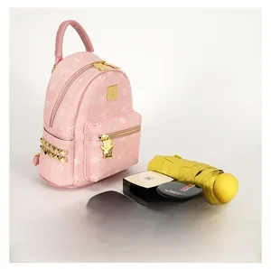 Pink mini backpack with bear print showing interior capacity for umbrella and cosmetics