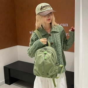 Simple light green nylon school backpack for kids with minimalist design and drip zippers