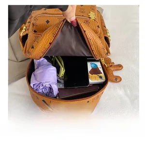 Detail showing high capacity interior of a brown bear print backpack with daily essentials