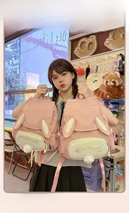 Detail of pink canvas backpack featuring cute bunny ears and star embroidery patterns