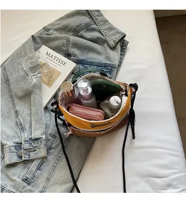 Internal view of fashion shoulder bag showing capacity for phone, wallet and cosmetics