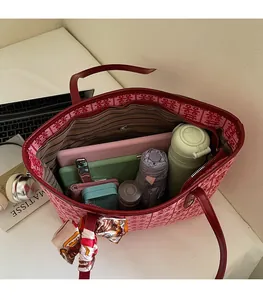 Top view of red Chinese wedding tote bag with double joy patterns and daily essentials