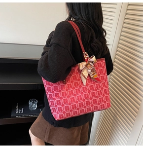 Detail of red festive tote bag with double happiness pattern and elegant silk scarf