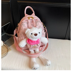 Pink PU backpack detail showing plush bear accessory and letter print pattern
