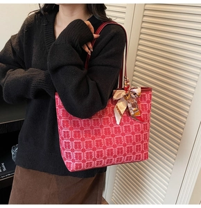 Detail of red festive tote bag with double happiness jacquard and elegant silk scarf handle