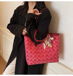 Close-up of red festive tote bag with traditional Double Happiness jacquard and silk scarf