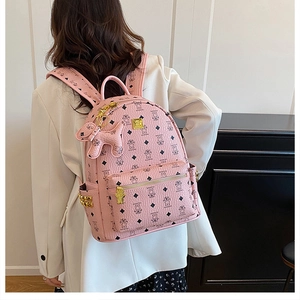 Pink PU leather backpack with bear prints, gold hardware, and a matching bear charm