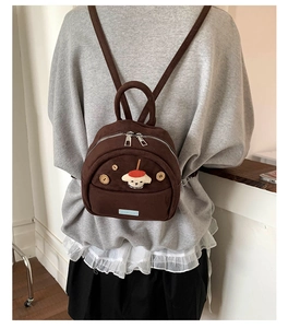 Close-up of a brown corduroy mini backpack featuring a cute 3D cartoon puppy design