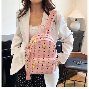 Pink faux leather backpack featuring cute bear print pattern and gold rivet accents