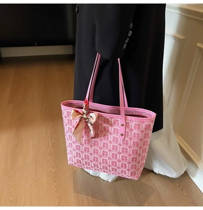 Close-up of pink tote bag with Double Happiness patterns and decorative handle scarf