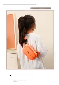 Close-up of orange waterproof nylon chest bag with metal zipper for kids on a model
