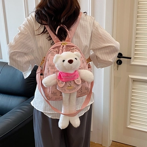 Pink mini backpack for women featuring cute white plush bear and adjustable straps
