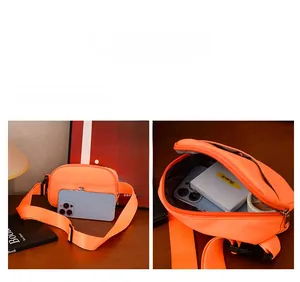 Compact orange nylon chest bag with multiple compartments and adjustable strap for kids
