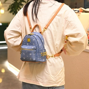 Mini denim backpack with cute cartoon bear print and stylish gold side rivet accents