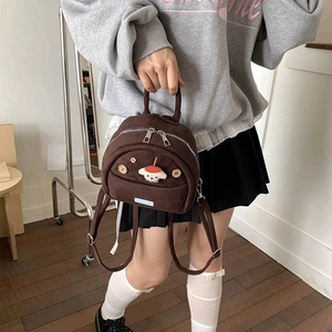 Cute brown plush mini backpack for women featuring a cartoon dog patch and dual zippers