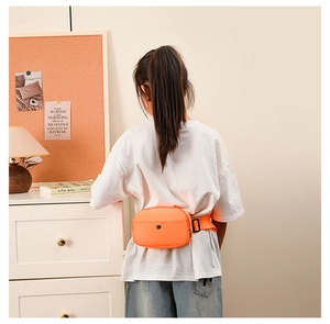Detailed back view of bright orange kids chest bag with adjustable shoulder strap