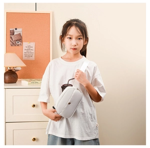 Close-up of minimalist white kids fanny pack with wide fabric strap on child model