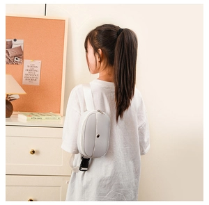 Close-up of white minimalist kids chest bag with adjustable nylon strap and buckle