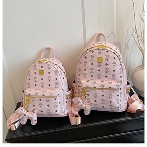 Pink PU leather backpack with bear print, gold studs, and matching bear charm detail