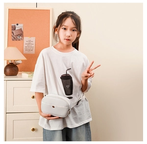 Kids minimalist white leather fanny pack shown on model in a cozy home interior setting