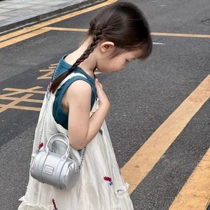 Silver mini cylindrical crossbody bag for kids with metallic litchi pattern leather detail